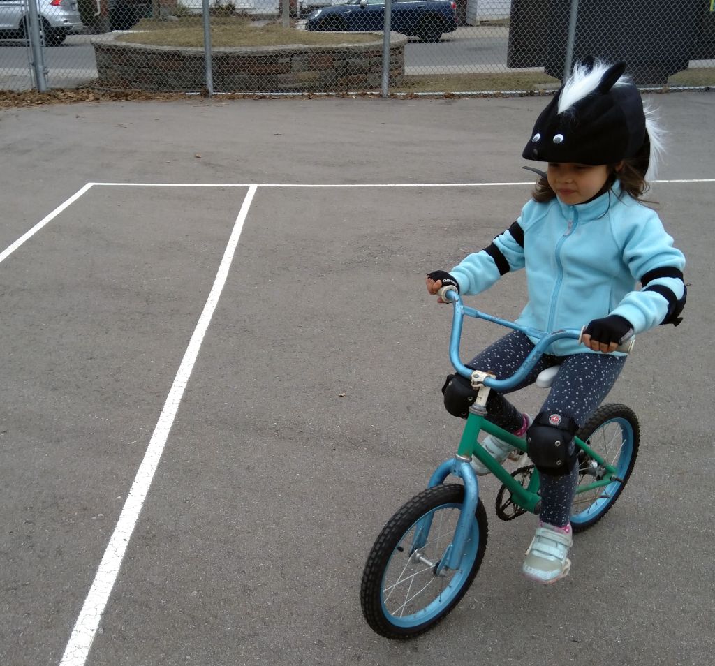 the girl, riding a bike at last