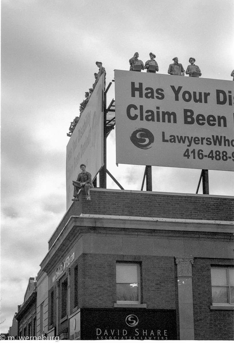 men working on a high billboard