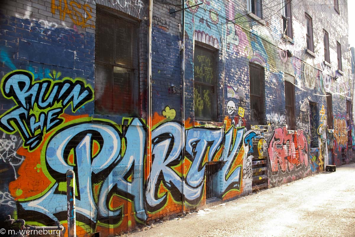 a riot of colorful graffiti in a Toronto alleyway