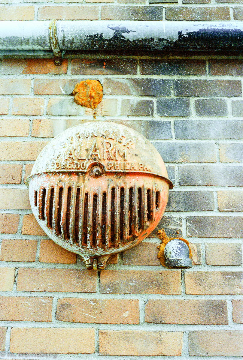 alarm bell, spattered with paint